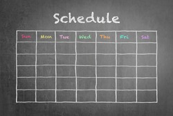 Schedule with grid time table on black chalkboard background