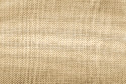 Jute hessian sackcloth natural burlap texture background in yellow gold brown color