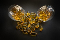 Fish oil in 2 glasses with black background 