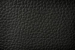Top view close up or macro of black creased or crumpled artificial leather textured background or wallpaper and abstract concept 