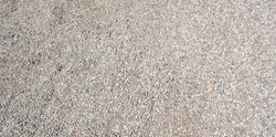Gravel texture. Small stones, little rocks, pebbles in many shades of grey, white, brown, pink colour. Crushed granite texture. Road made of stones. Small rock background. Banner for web site.