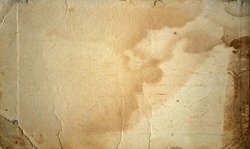 The texture of old yellowed cardboard with spots.