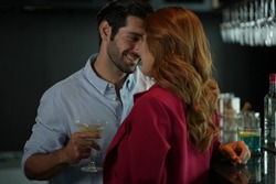 Man and woman flirting with each other in bar At Evening Party. Romantic couple dating at night in pub. couple dating , propose marriage. Romantic couple on a date sitting in a restaurant. 