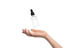 Serum hovering or flying over a woman's hand, isolate