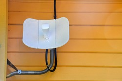 Outdoor router, street access point, coverage WI-FI area repeater. Street router for the Internet hangs on the wall