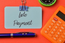 Blue card written with text LATE PAYMENT. Business concept