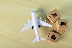 Stack of cardboard boxes and airplane with fast delivery of goods and products . Commodity trading, logistics, air cargo, parcels, airmail, shipping, fast delivery concept.