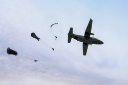 Military parachutist on the background of blue sky. Rangers parachuted from military airplanes. Soldiers parachuted from the plane.