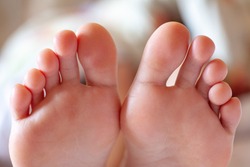 young girl's toes are healthy and beautiful. Well-groomed toes. Concept for medical articles and ointments - the image of the toes and feet. Image of legs with space for inscriptions and advertising.