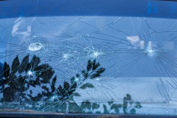 broken glass. Car glass cracked from an accident. Armored glass after impact. glass reinforced with a film after being hit by a bullet.