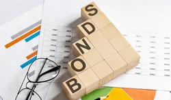 BONDS words with wooden blocks on chart background. Business concept.