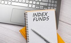 INDEX FUNDS text written on notebook on the laptop