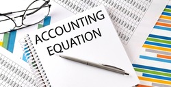 ACCOUNTING EQUATION , pen and glasses on chart, business concept