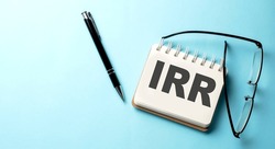 IRR Internal Rate of Return text written on notepad on the blue background