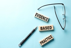 Text EBP Evidence-based practice concept on wooden block on blue background