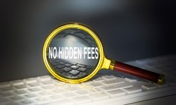 NO HIDDEN FEES word concept on magnifier on the keyboard