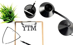 YTM - Yield To Maturity text on clipboard on the white background