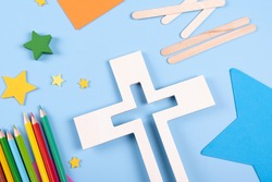 Vacation Bible School craft supply with wooden cross. Christian concept. Copy space text. Selective focus.