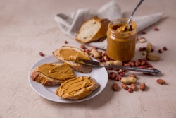 Peanut butter, nuts, peanut bread. Lifestyle Sweet breakfast for children and adults. Background picture. Beige and brown colors.