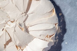 Homemade meringue. Large meringue on baking paper. Baking at home. Pavlova cake. Birthday cake.