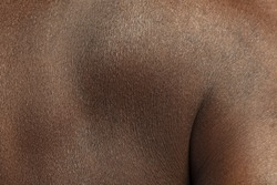 Back. Detailed texture of human skin. Close up shot of young african-american male body. Skincare, bodycare, healthcare, hygiene and medicine concept. Looks beauty and well-kept. Dermatology.