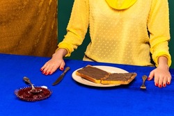 Breakfast. Food pop art photography. Food pop art photography. Cropped portrait of girl and sweet chocolate toasts on blue tablecloth. Vintage, retro 80s, 70s style. Complementary colors, Copy space