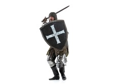 Portrait of brutal serious man, medieval warrior or knight in protective covering with sword preparing to attack isolated over white studio background. Comparison of eras, history, renaissance style