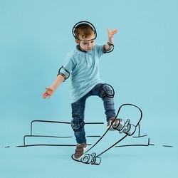 Creative portrait of cute kid, little boy skating on drawn skateboard isolated on blue background with pencil sketch. Concept of emotions, ideas, imagination, international children's day.
