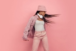 Freestyle. Monochrome portrait of young attractive happy woman in casual style outfit isolated on pink background. Concept of beauty, art, fashion, youth, sales and ads. Looks happy, delighted.