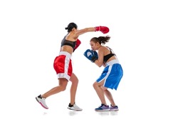 Rivals. Couple of female professional boxers training isolated on white studio background. Fit muscular women in sports uniform fighting. Sport, competition, show, power, action concept.