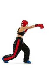 Punching. Professional boxer in boxing gloves and helmet training isolated on white studio background. Sport, competition, hobby, results, success concept. Sportive woman practicing in boxing.