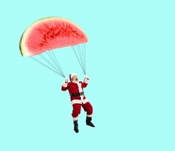 Contemporary artwork. Creative design. Cheerful senior man in image of Santa Claus flying on watermelon like paraglider. Concept of holiday, winter vacation, New Year, Christmas, creativity, fun, ad