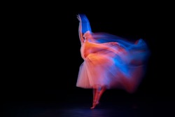 Dance of light and glow. Beautiful grace girl, female ballet dancer dancing isolated over black background in mixed neon light. Art, motion, action, flexibility, creativity and ad concept.