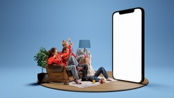 Expressive young people, emotional friends watching horror movie together over blue background. Youth sitting on sofa in front of huge 3D model of cellphone screen. Concept of sport, leisure