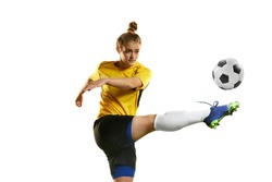 Hitting ball with leg. Young professional female football player in motion, training, playing football, soccer isolated over white background. Concept of sport, action, motion, competition, hobby, ad.