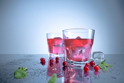 closeup of a cape cod cocktail or vodka cranberry on a blue background