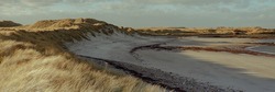 Panoramic view of a deserted beach in Northumberland UK.