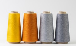 colorful bobbins of thread isolated on white background.