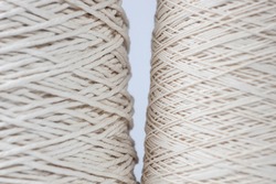 close-up of two spools of thread, perfectly smooth winding.