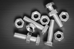 set nuts and bolts on a black wooden background