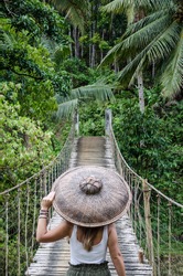
young woman on a bridge in the jungle