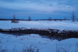 Landscape of a river in winter at dusk