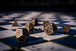 Close-up image of a set of Role-playing gaming dice on black and white tiles
