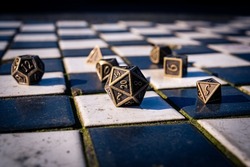 Close-up image of a set of Role-playing gaming dice on black and white tiles