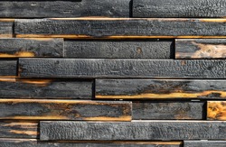 texture of burnt boards. Blackened charred wood planks with light veins. Burnt scratched hardwood surface. Background for Halloween.