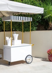 white champagne trolley. ice cream cart for mockup. Summer cart, summer trolley. Luxury cart.