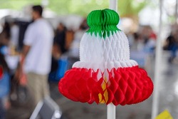 Tricolor bell-shaped paper ornament with the colors of the Mexican flag. Celebration of Fiestas Patrias in Mexico.
