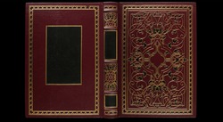 Old antique open book cover in red canvas and embossed golden decorations, isolated, XL size