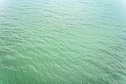 Ocean water with green color and ripples