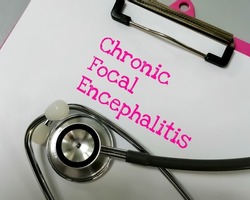  Chronic Focal Encephalitis (CFE) medical term, a kind of persistent brain inflammation, results in severe epileptic activity, such as persistent, focal seizures. notepad with stethoscope.